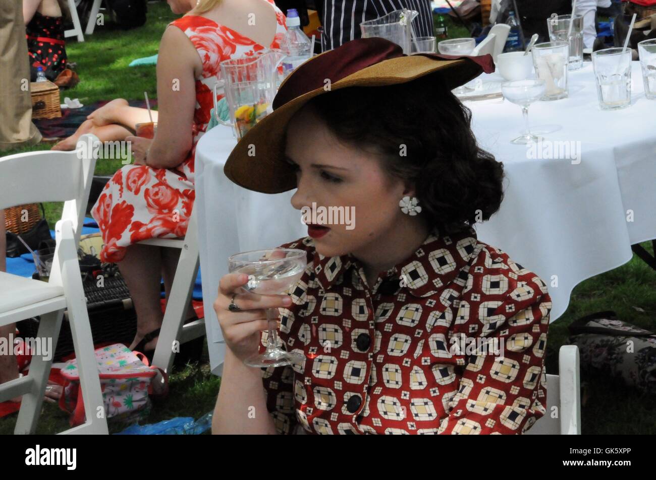 A Lady drinks a cocktail, at the 2016 Chap Olympiad. Stock Photo