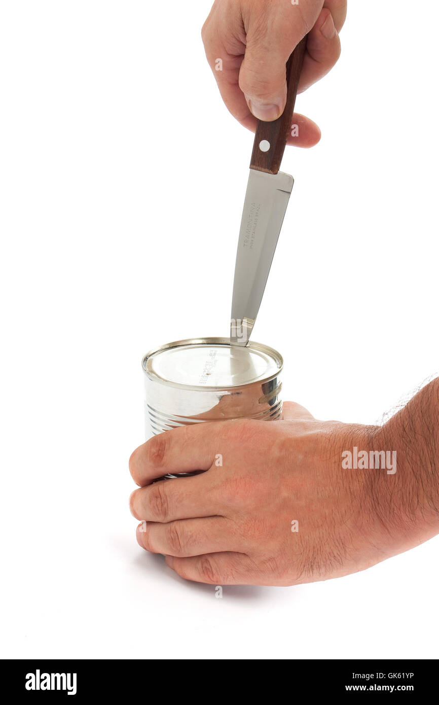 opening a metal tin with a knife Stock Photo Alamy