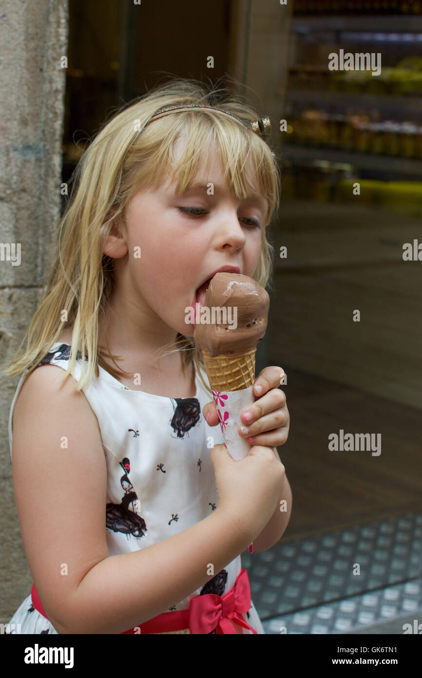adorable young girl eating chocolate ice cream cone Stock Photo - Alamy