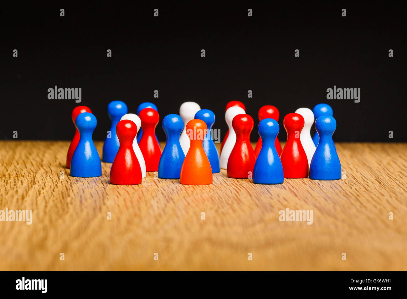 Concept for kingdom of The Netherlands. Orange king amongst red white blue pawns representing the people. Stock Photo