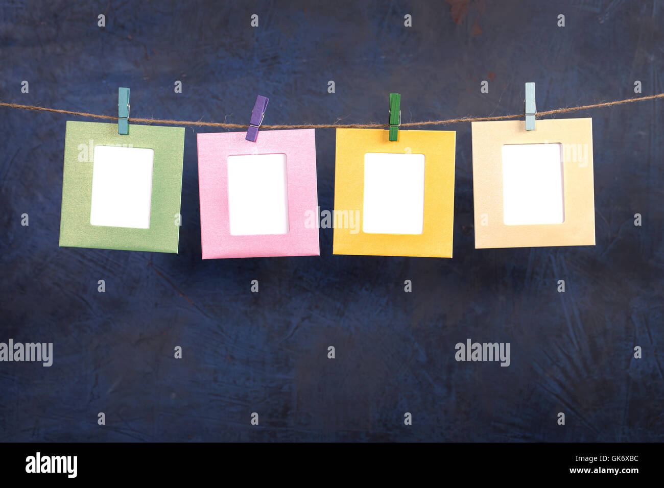 Four frames hanging on rope on dark background Stock Photo Alamy