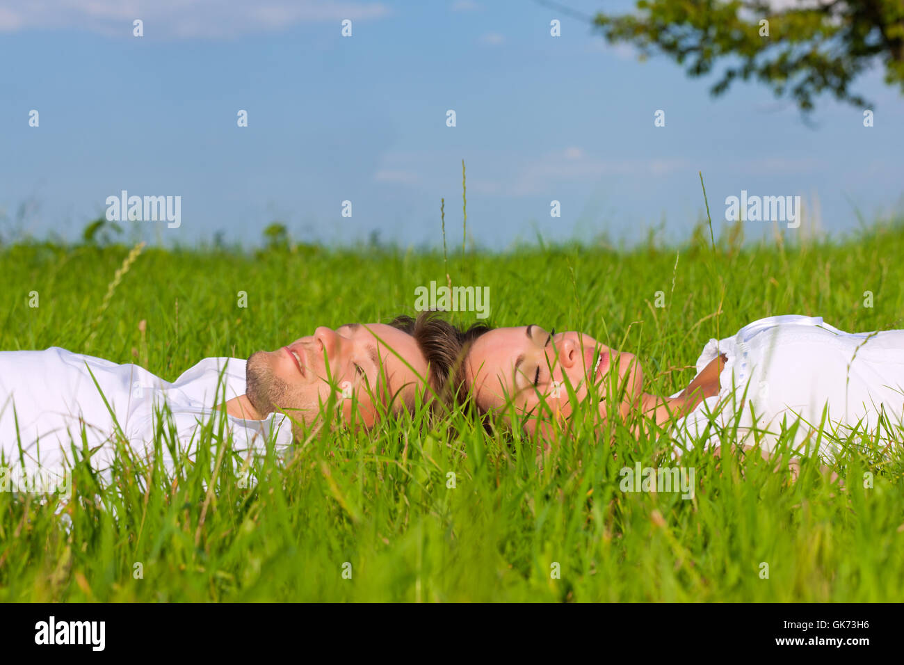 happy couple lying on a meadow Stock Photo