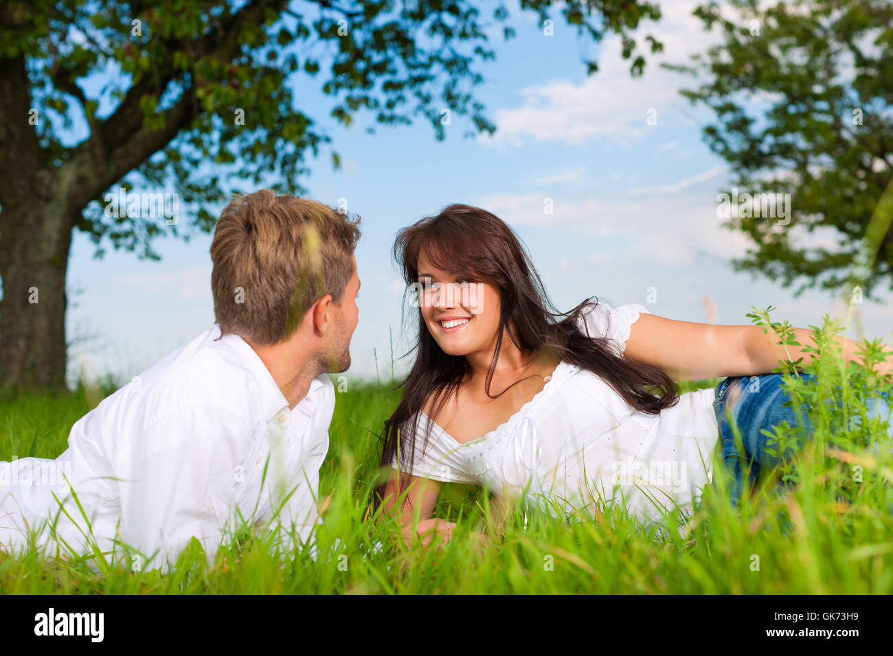 happy couple lying on a meadow Stock Photo
