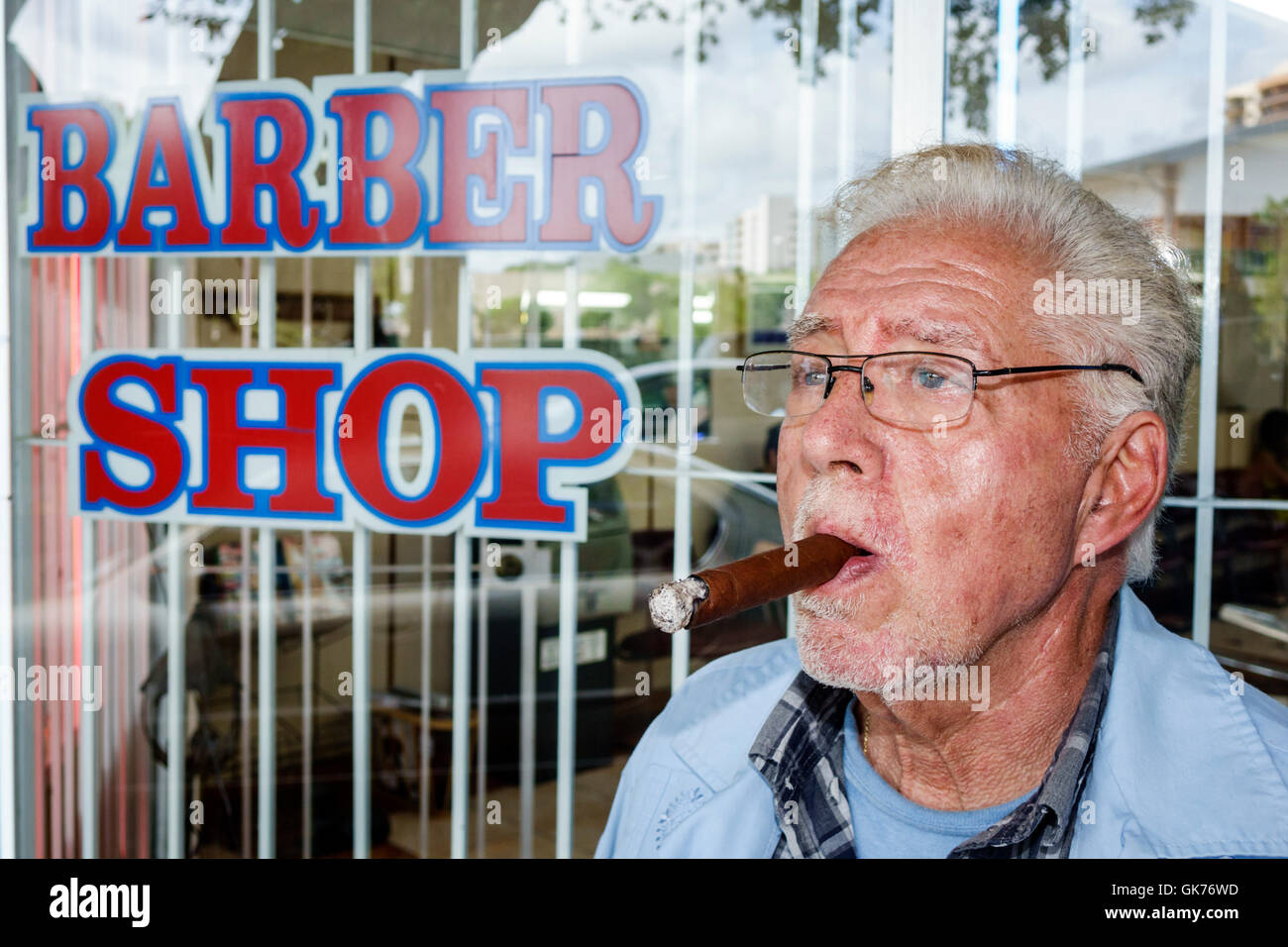 Miami Florida,Coral Way,barber shop,exterior,sign,small business,personal grooming,Hispanic adult,adults,man men male,mature,barber,smoking,cigar,gray Stock Photo