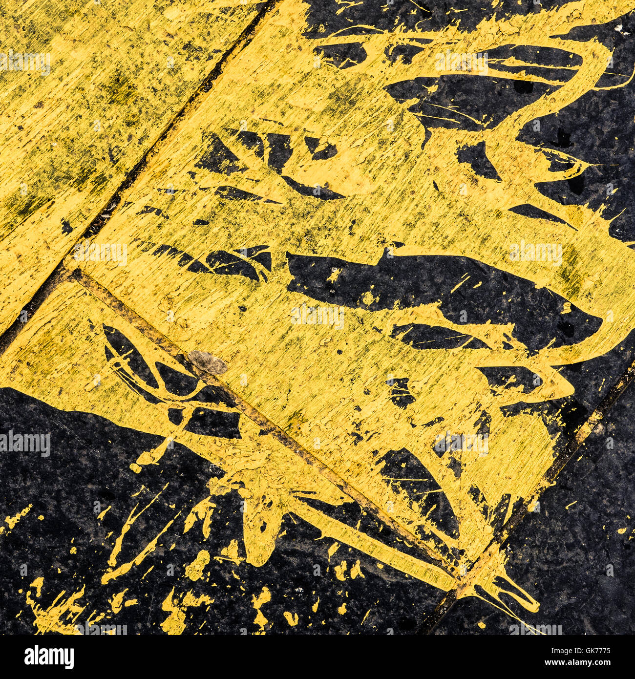 Yellow Paint Spilled On Black Tarmac Stock Photo