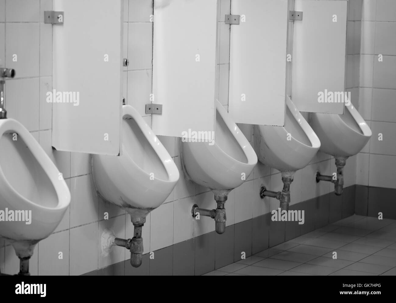 old white porcelain urinals in public toilets Stock Photo Alamy