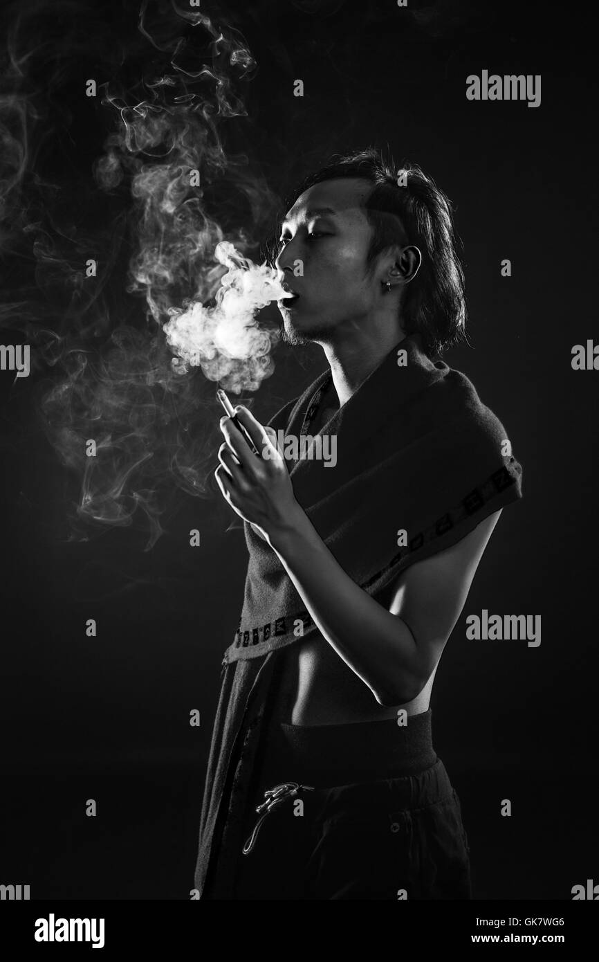 A side view of a man smoking Stock Photo