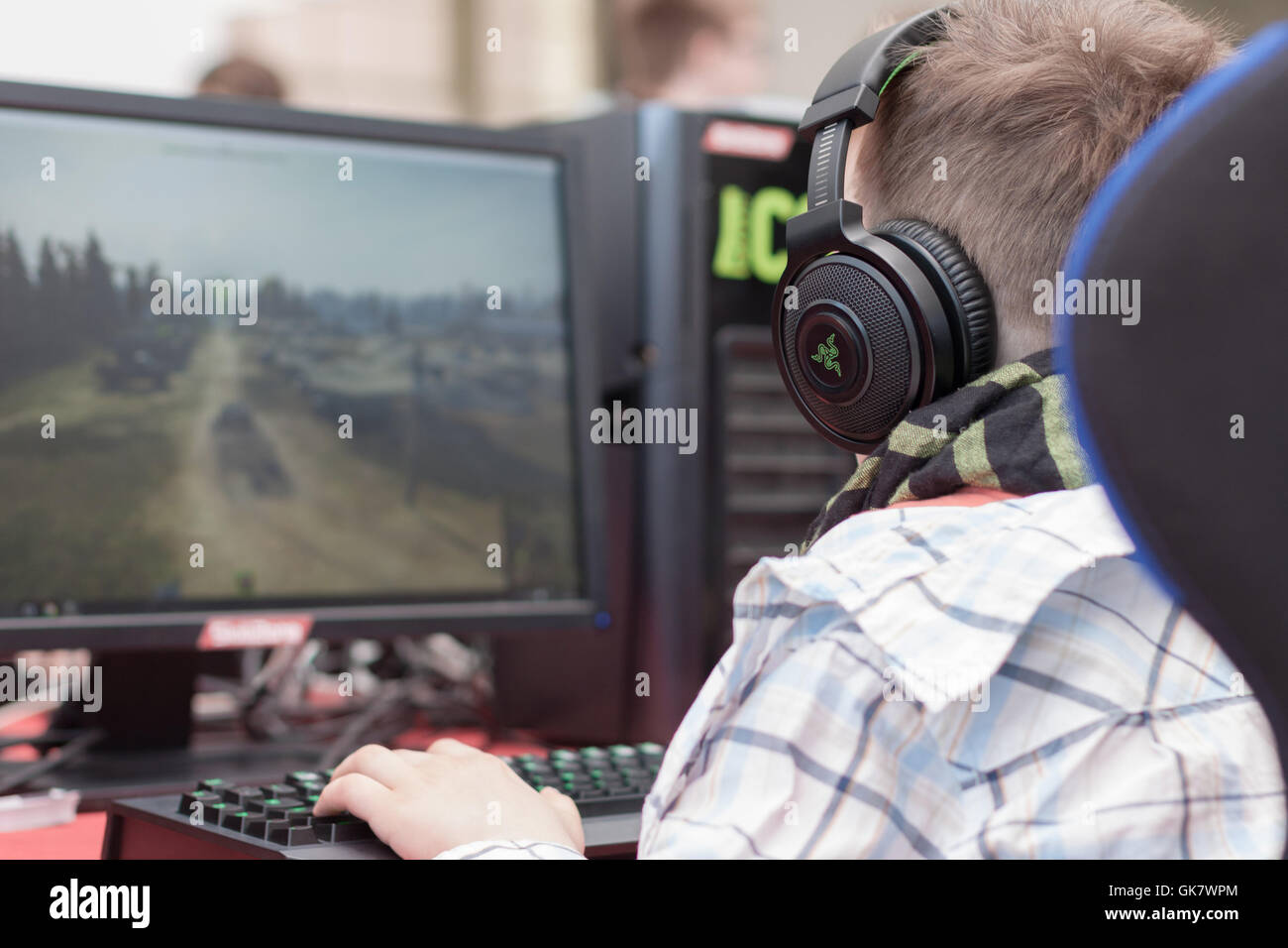 BRNO, CZECH REPUBLIC - APRIL 30, 2016: Young man sits on gaming chair and plays game on PC at Animefest, anime convention Stock Photo