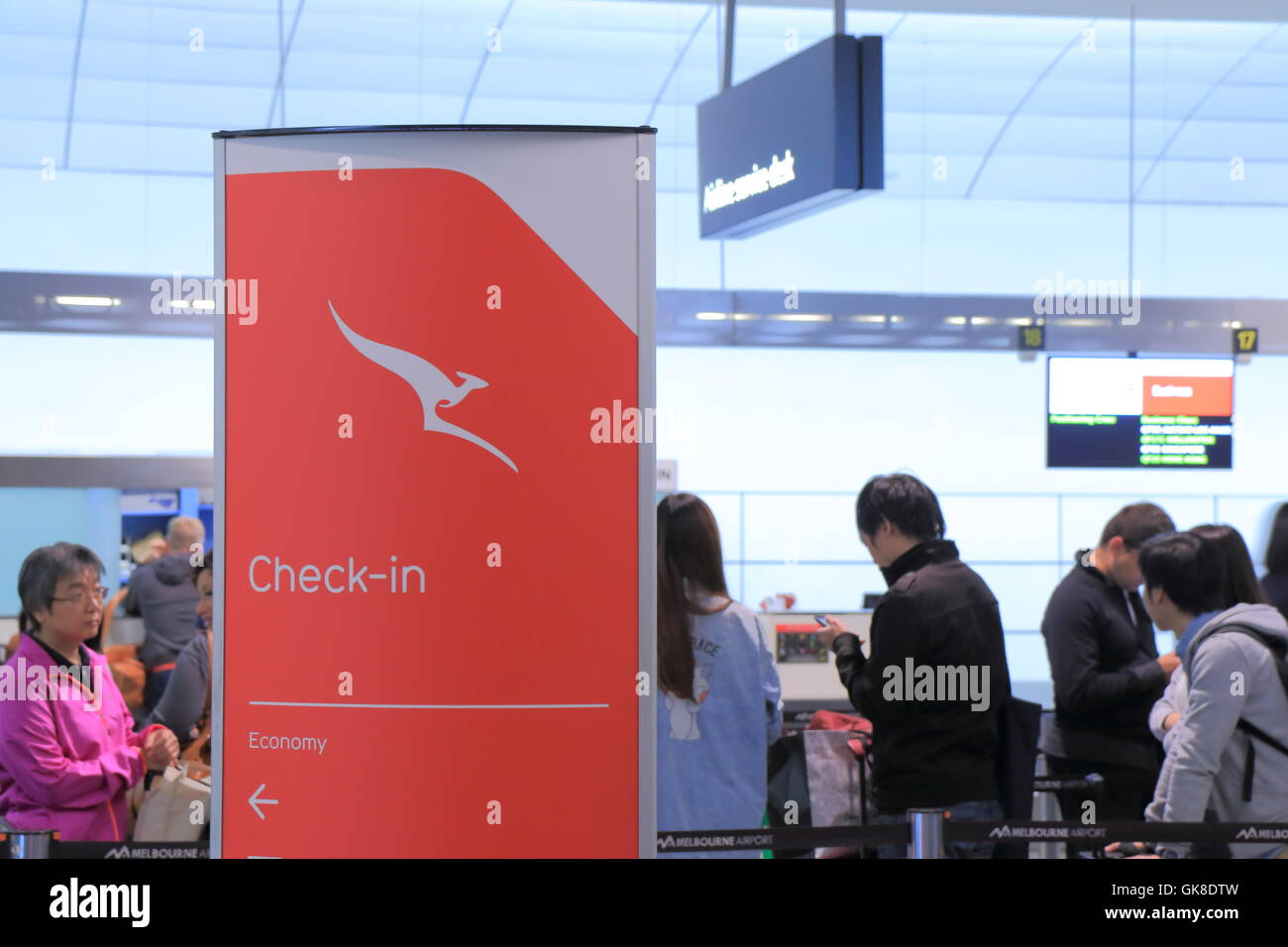 People queue at Melbourne Airport Qantas check in counter in Melbourne Australia. Stock Photo