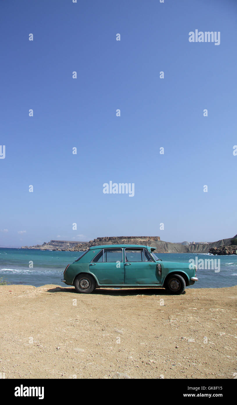 An old rusty car abandoned on a beach Stock Photo