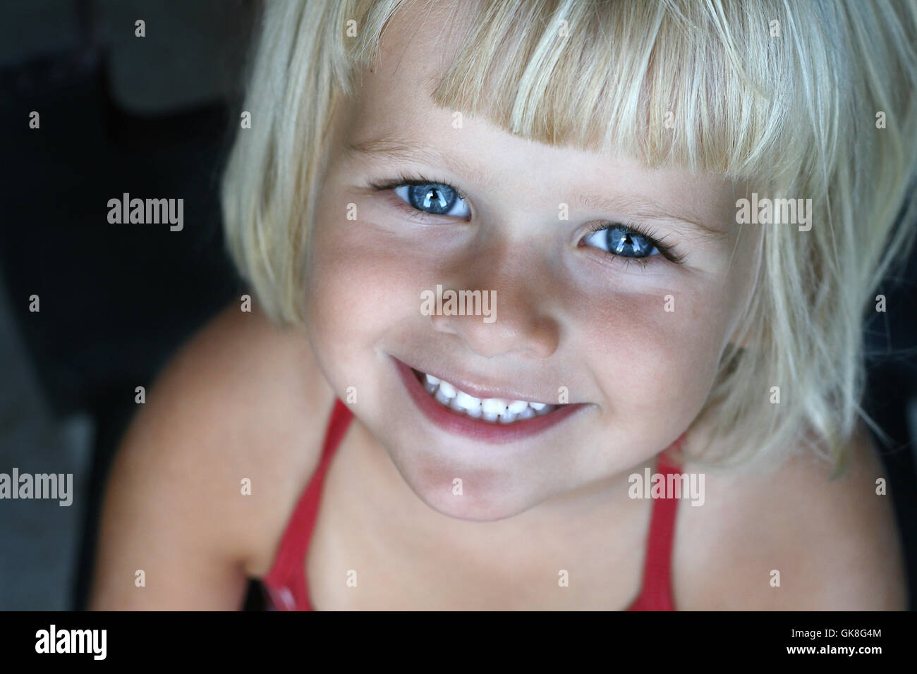 Little girl smiling at camera Stock Photo - Alamy