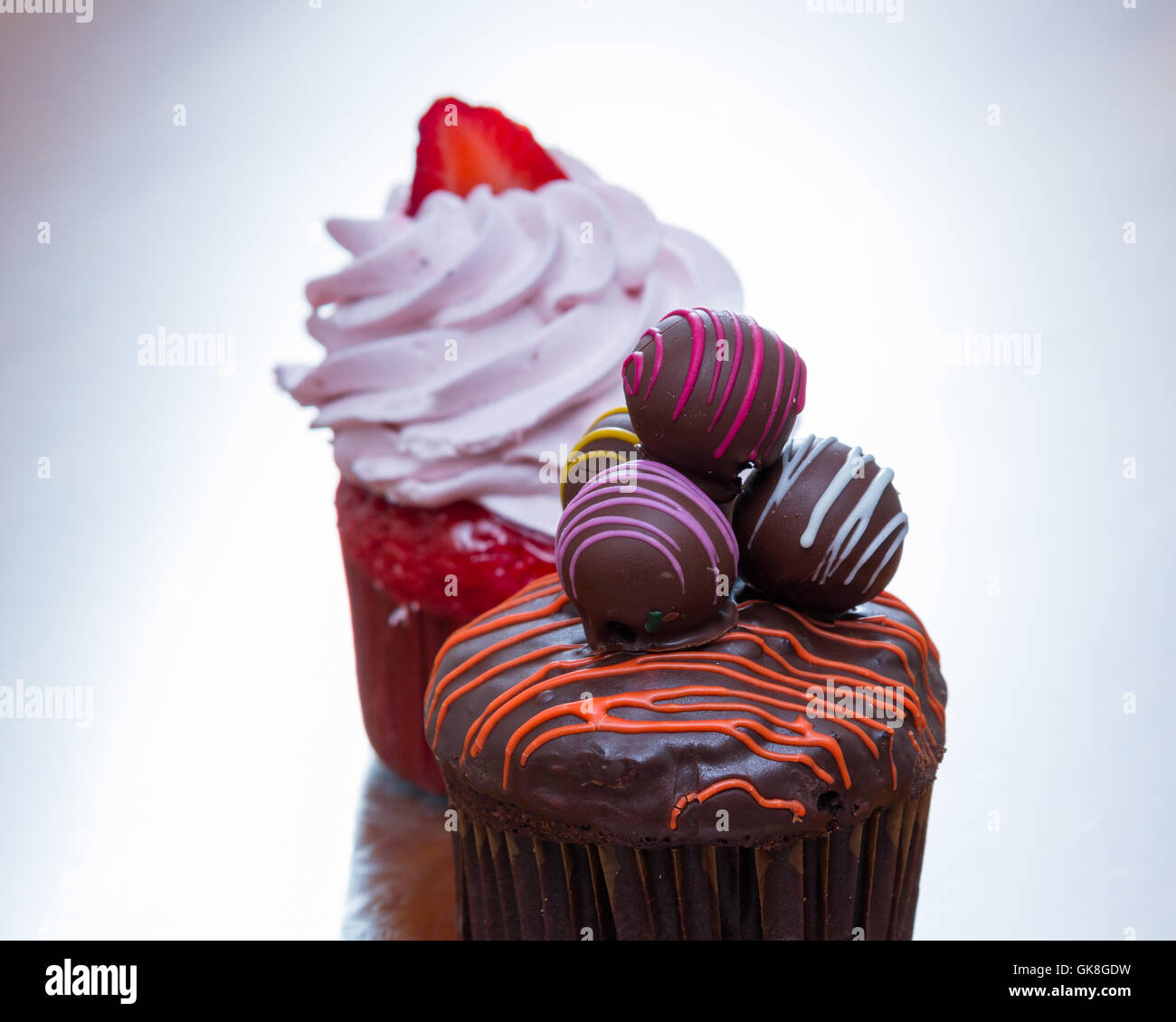 delicious chocolate truffle cupcake with a strawberry cupcake in the