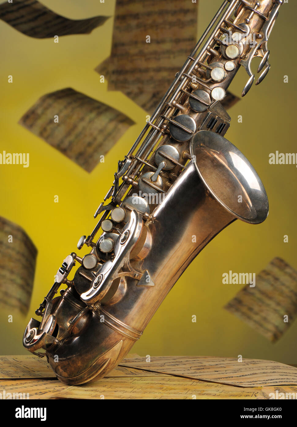 Old saxophone and flying musical notes on a background Stock Photo - Alamy