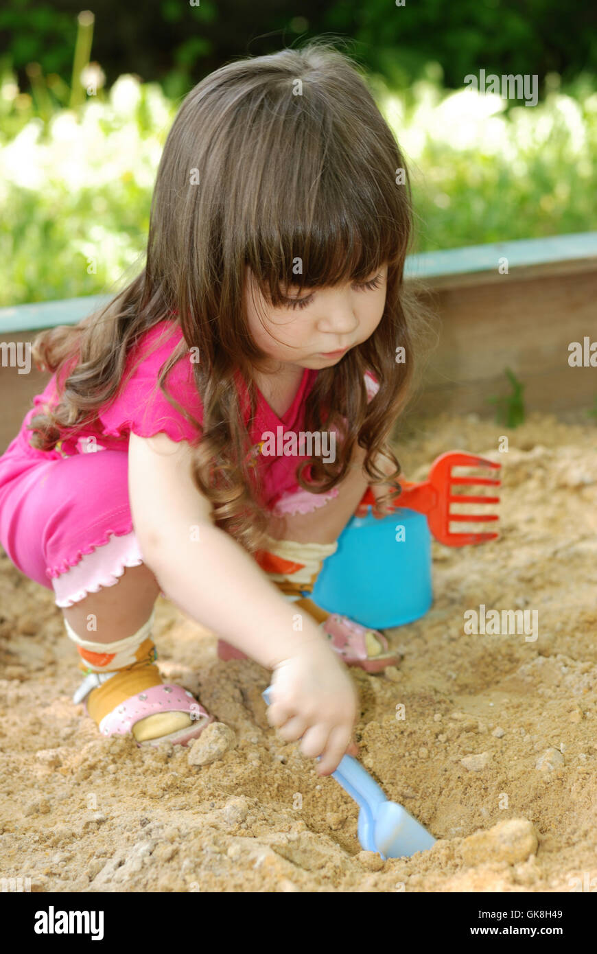 The girl playing to a sandbox Stock Photo