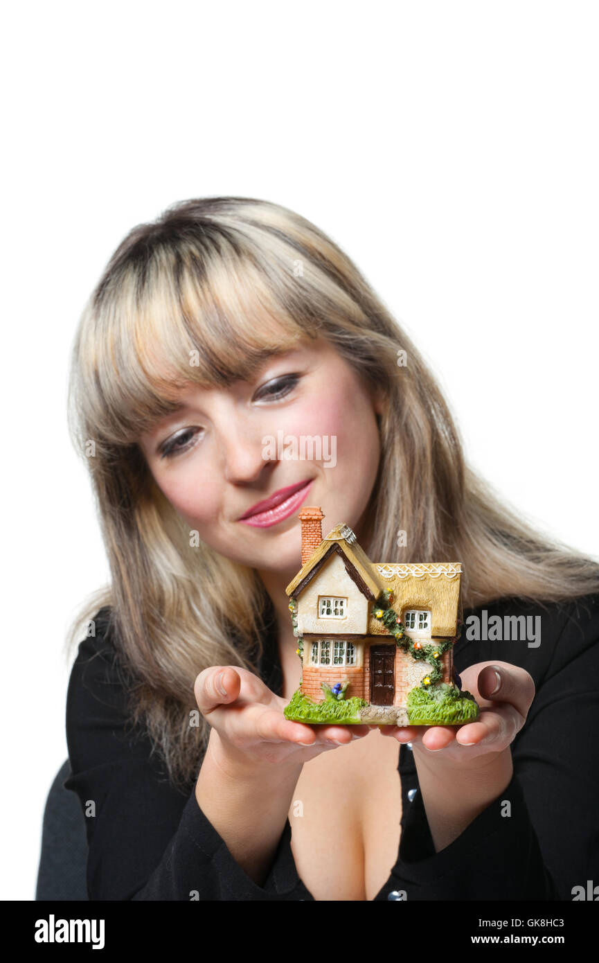 The business woman holds the small house in the hands Stock Photo - Alamy