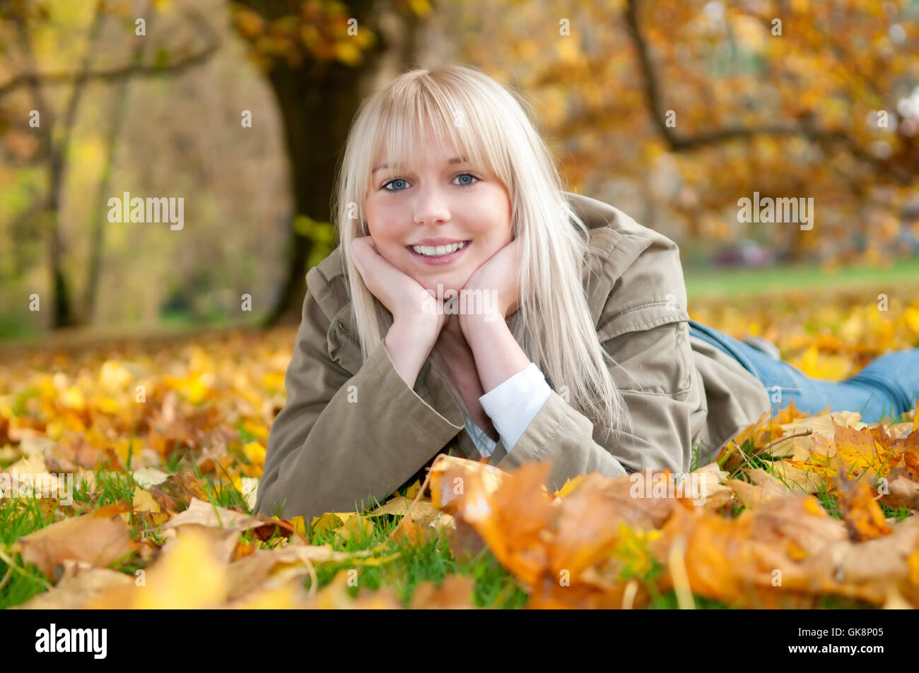 teenager in fall leaves Stock Photo