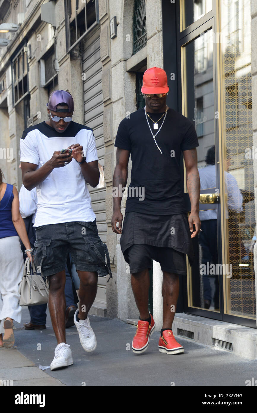 Mario Balotelli and his brother Enock Barwuah in downtown Milan ...