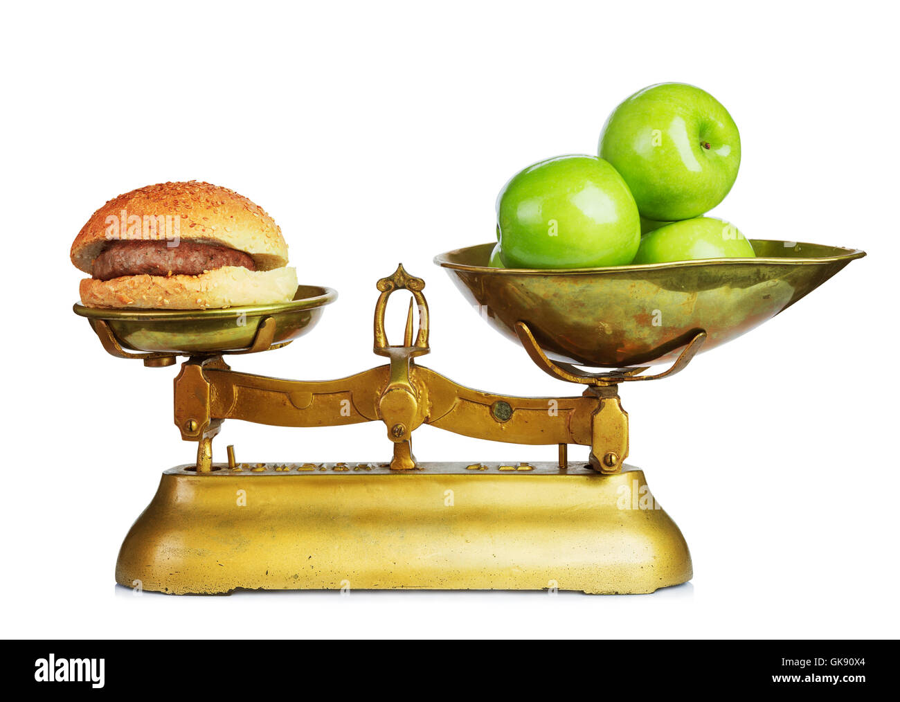 Healthy food and unhealthy food on old retro scales.Dieting concept.Isolated. Stock Photo