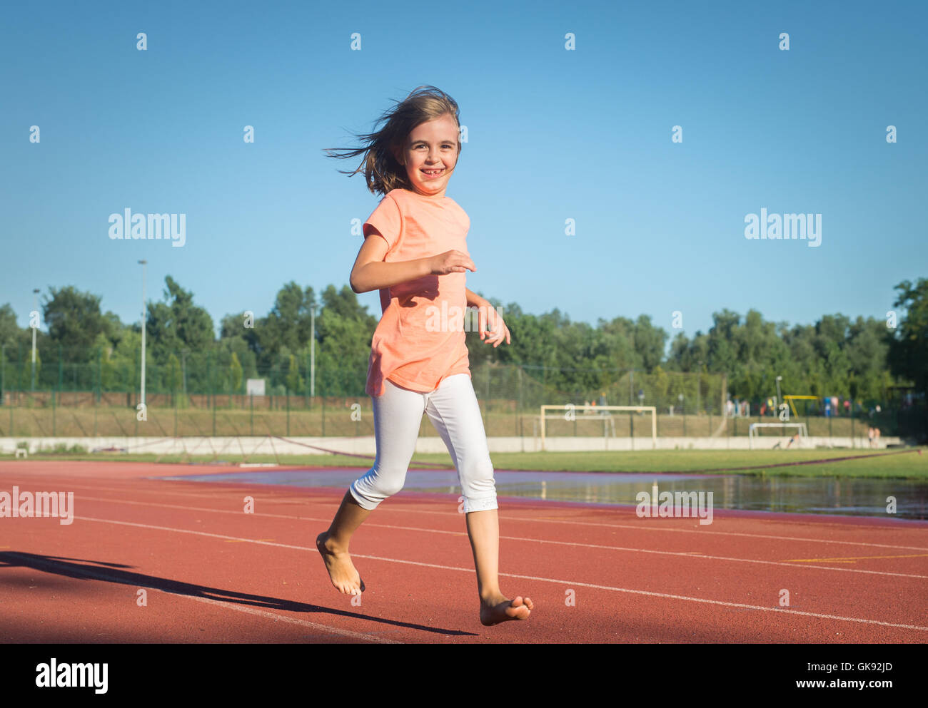 Happy girl run on the track Stock Photo Alamy