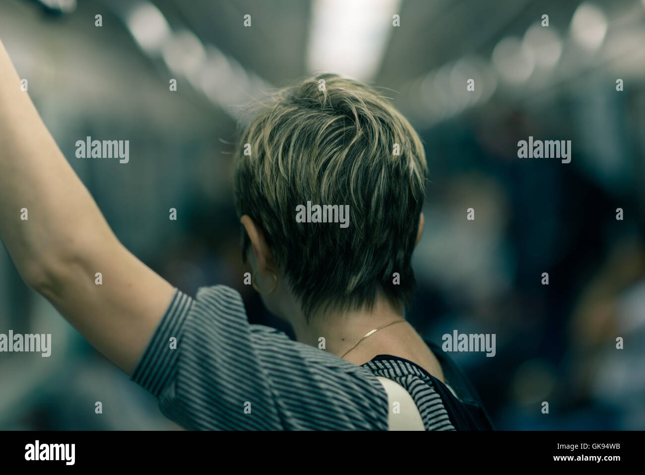 Woman With Short Haircut In The Metro Is Back Stock Photo