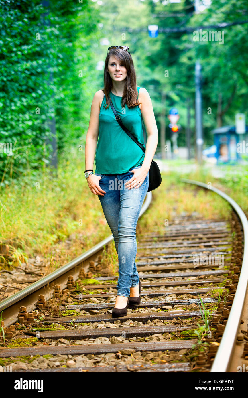 Young girl walking on train tracks hi-res stock photography and images ...