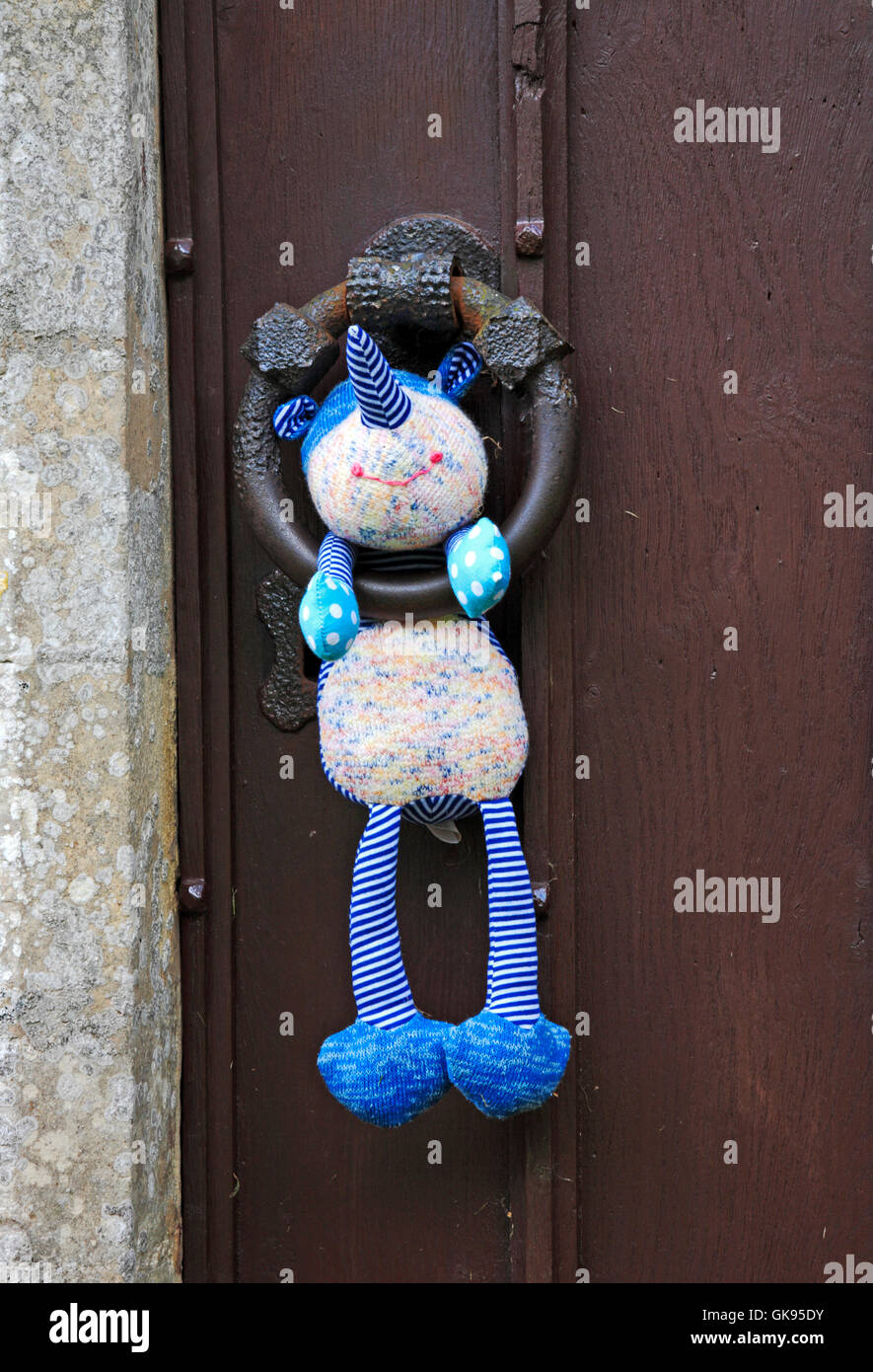 A cuddly toy placed on the church door handle at Dunston, Norfolk, England, United Kingdom. Stock Photo