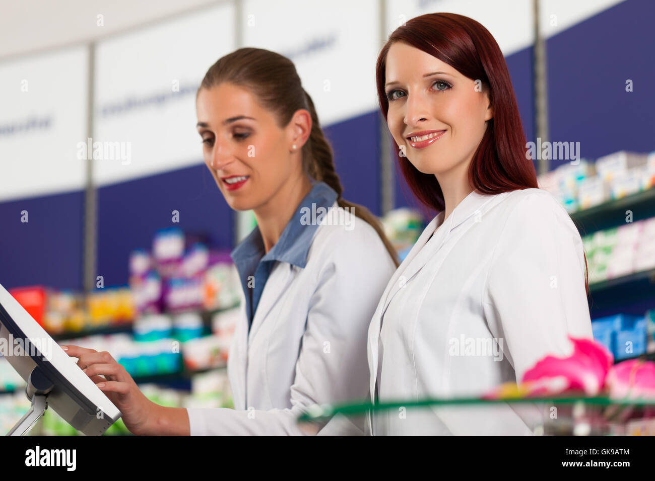pharmacist with assistant in pharmacy drugstore Stock Photo Alamy
