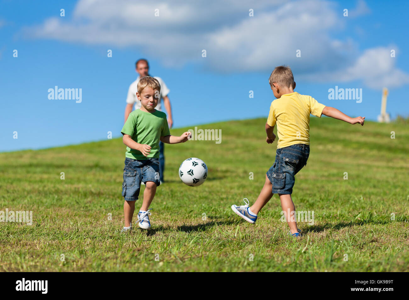 happy family is playing soccer in summer Stock Photo - Alamy