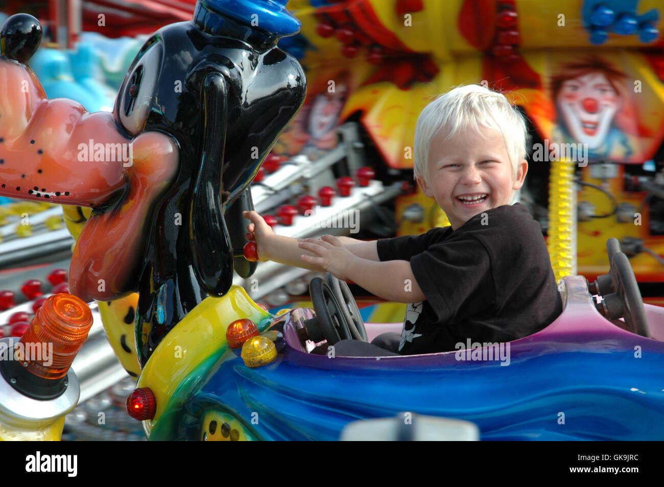 boy drives carousel Stock Photo