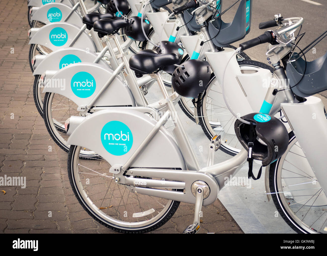 Mobi bicycles on Anderson Street.  Mobi Bike Share is the City of Vancouver's bicycle sharing program. Stock Photo