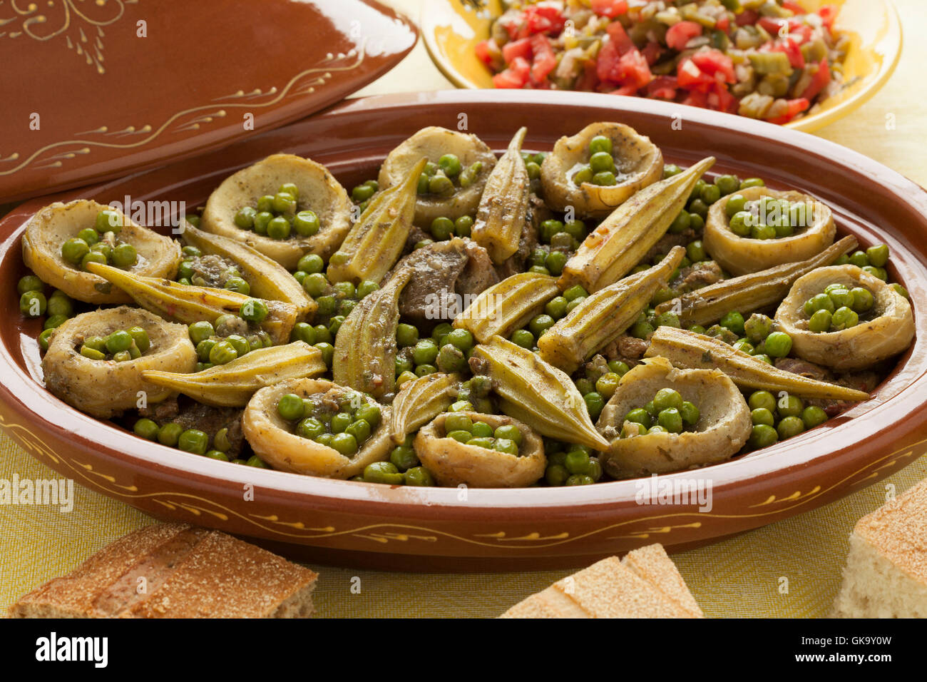 Moroccan oval tajine with meat, okra, green peas and artichoke hearts