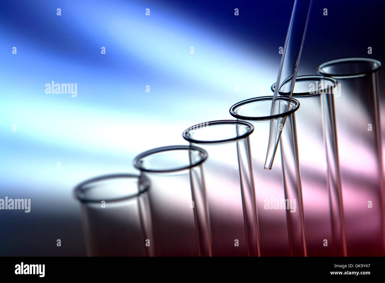 Laboratory pipette inside empty glass test tubes for a scientific ...