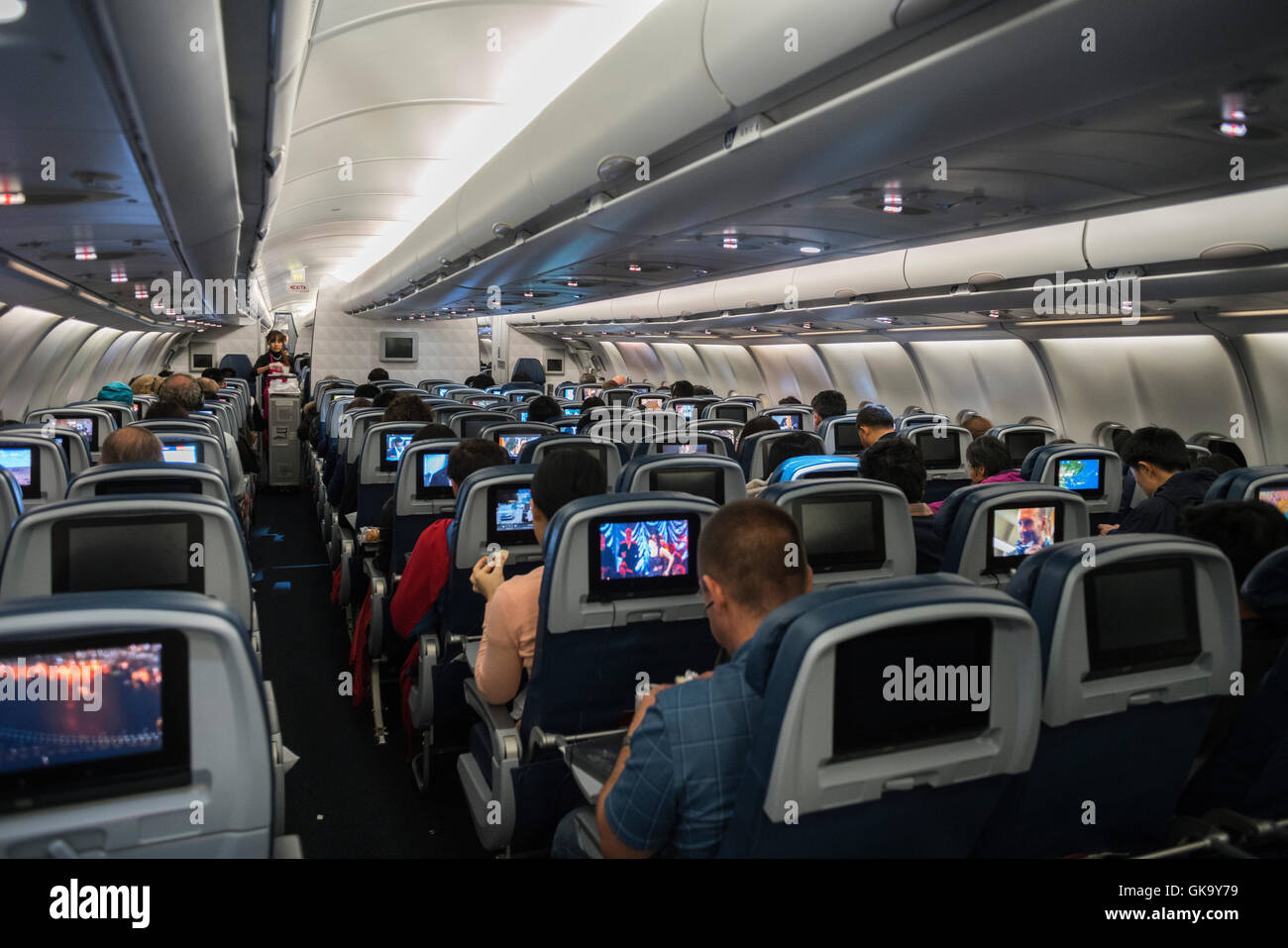 Commercial aircraft cabin aisle seat row Stock Photo Alamy