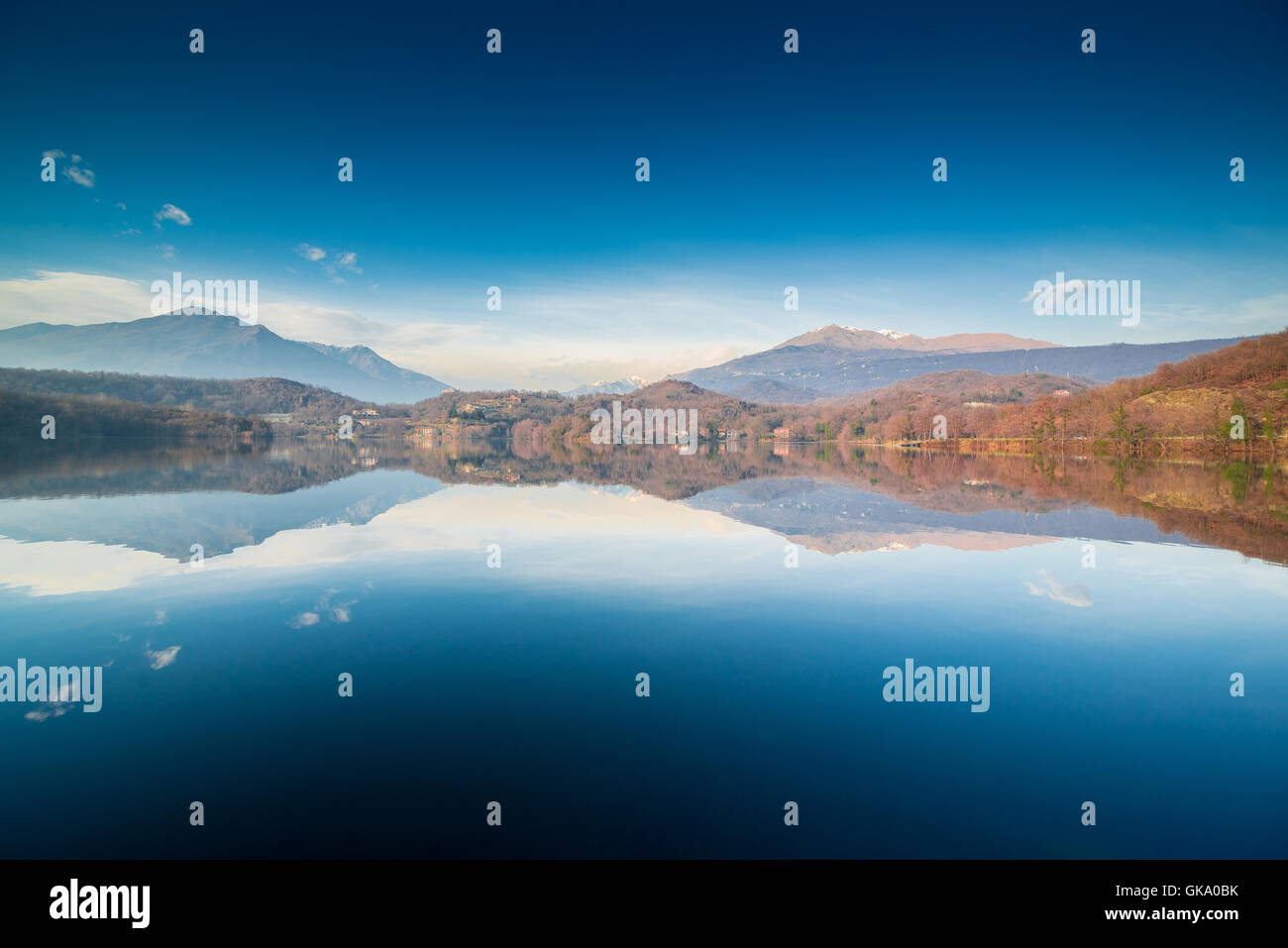 Wonderful scene of a serene lake with mountains in the background, calm water, symmetric reflections Stock Photo