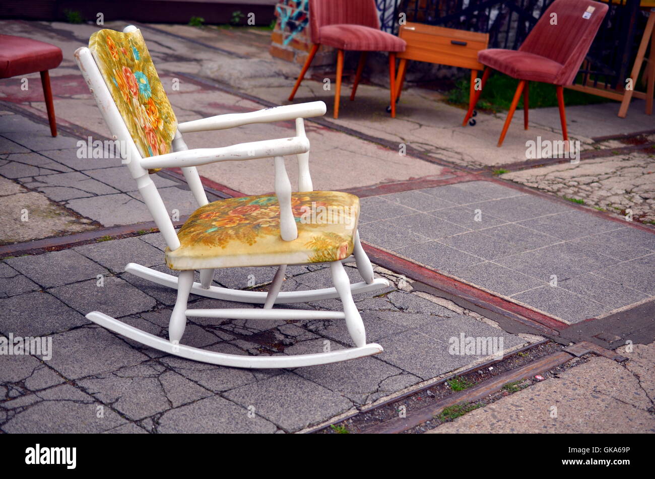 white vintage rocking chair on the street Stock Photo