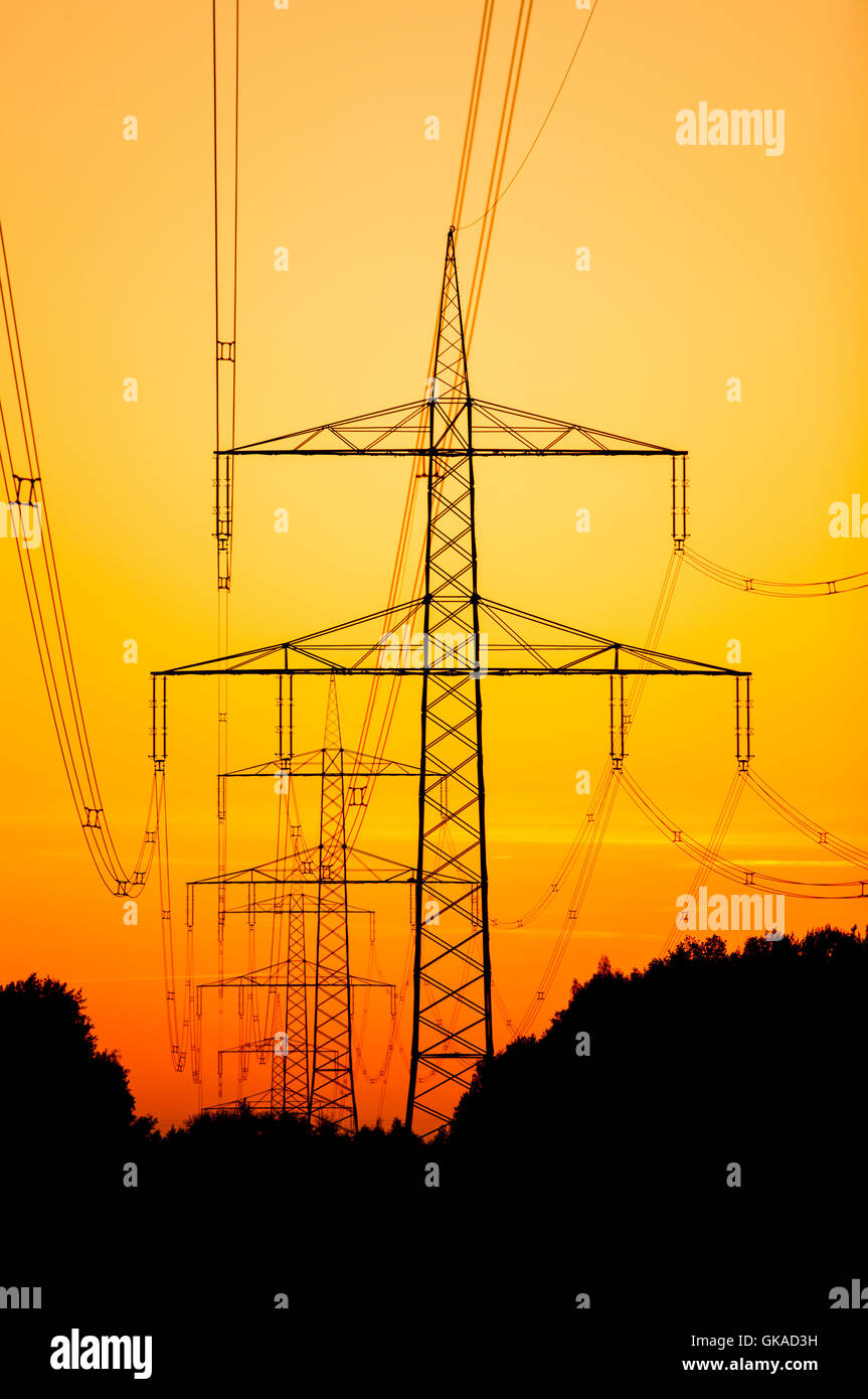 electricity pylons in the sunset Stock Photo
