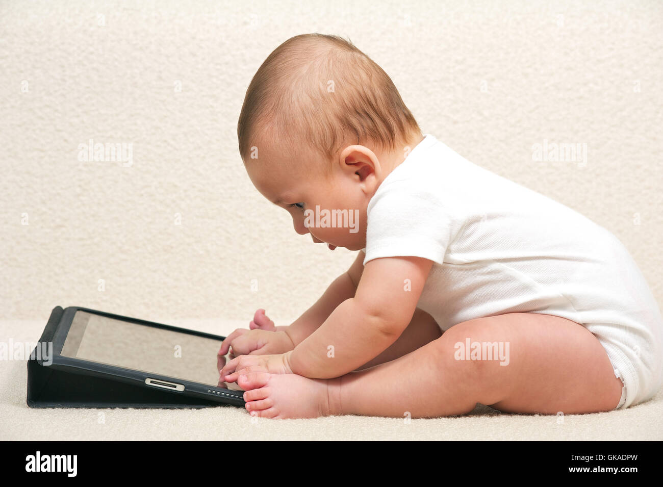 baby spilled hit computer Stock Photo