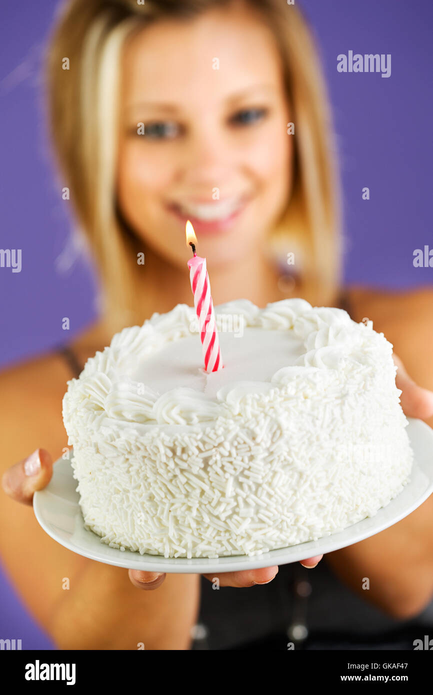 Pretty woman holding birthday cake with candle Stock Photo - Alamy