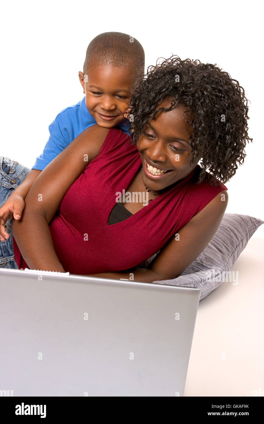 African American Mother And Son Making Cookies In Kitchen And In