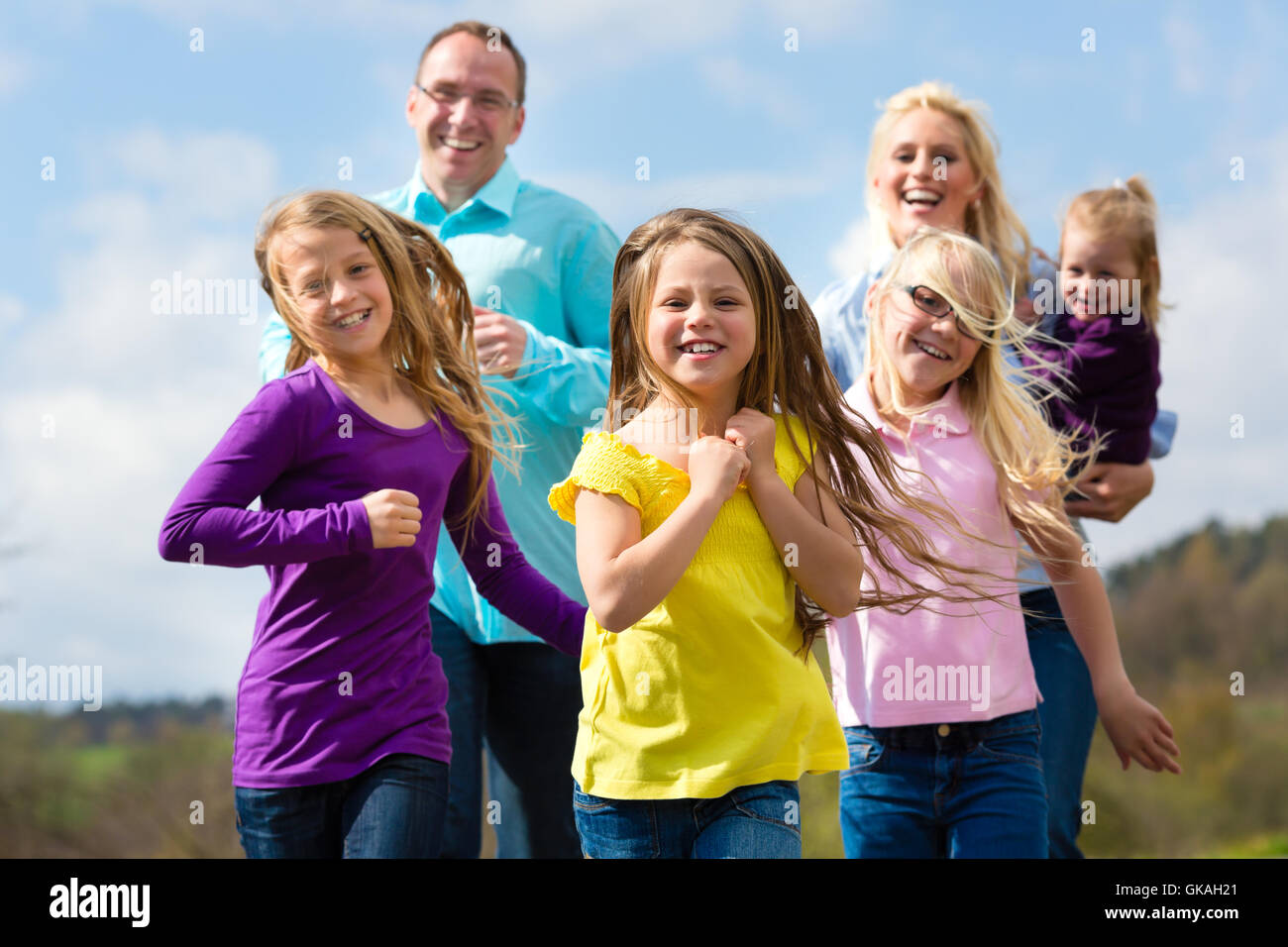 family jogging outdoors Stock Photo
