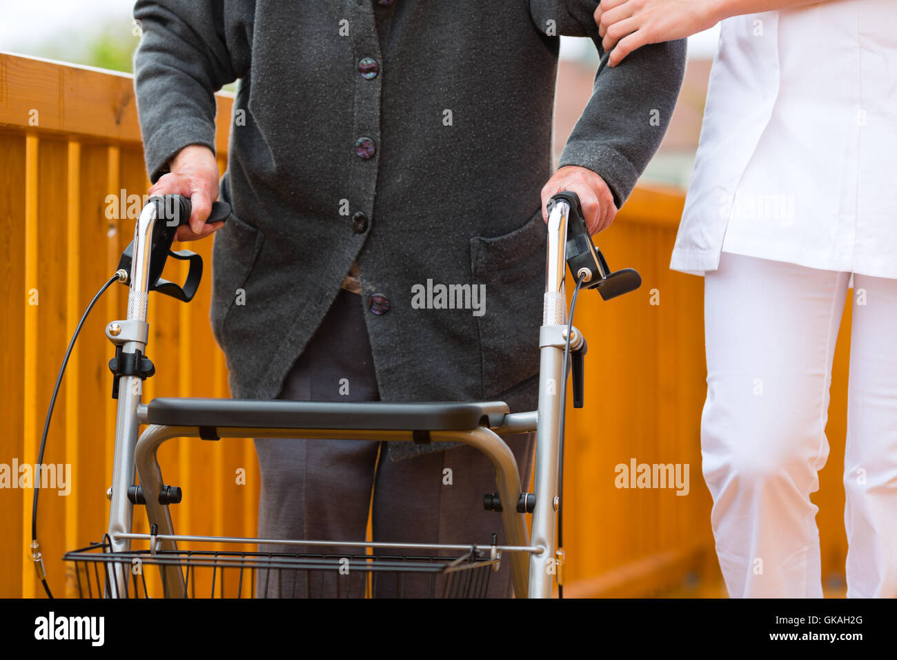 age and nursing - nurse and a senior citizen with walker Stock Photo