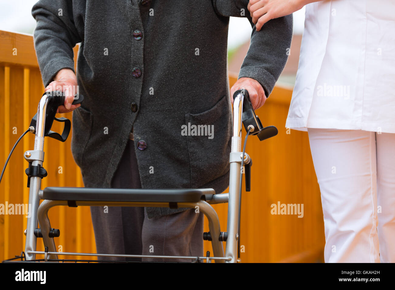 age and care - nurse and a senior citizen with walker Stock Photo