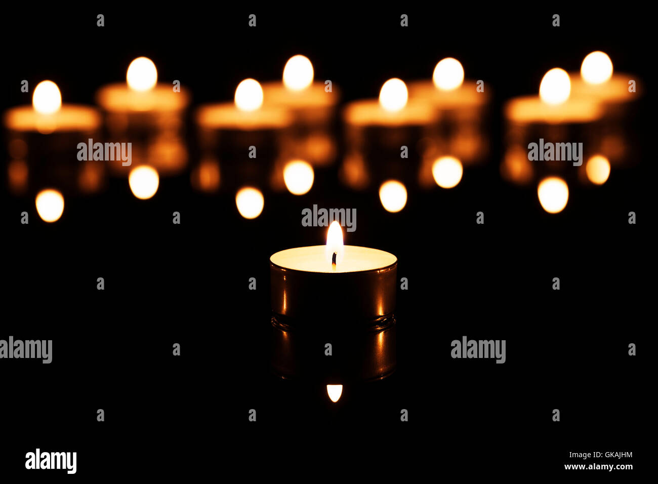 a tea light in front of many Stock Photo Alamy