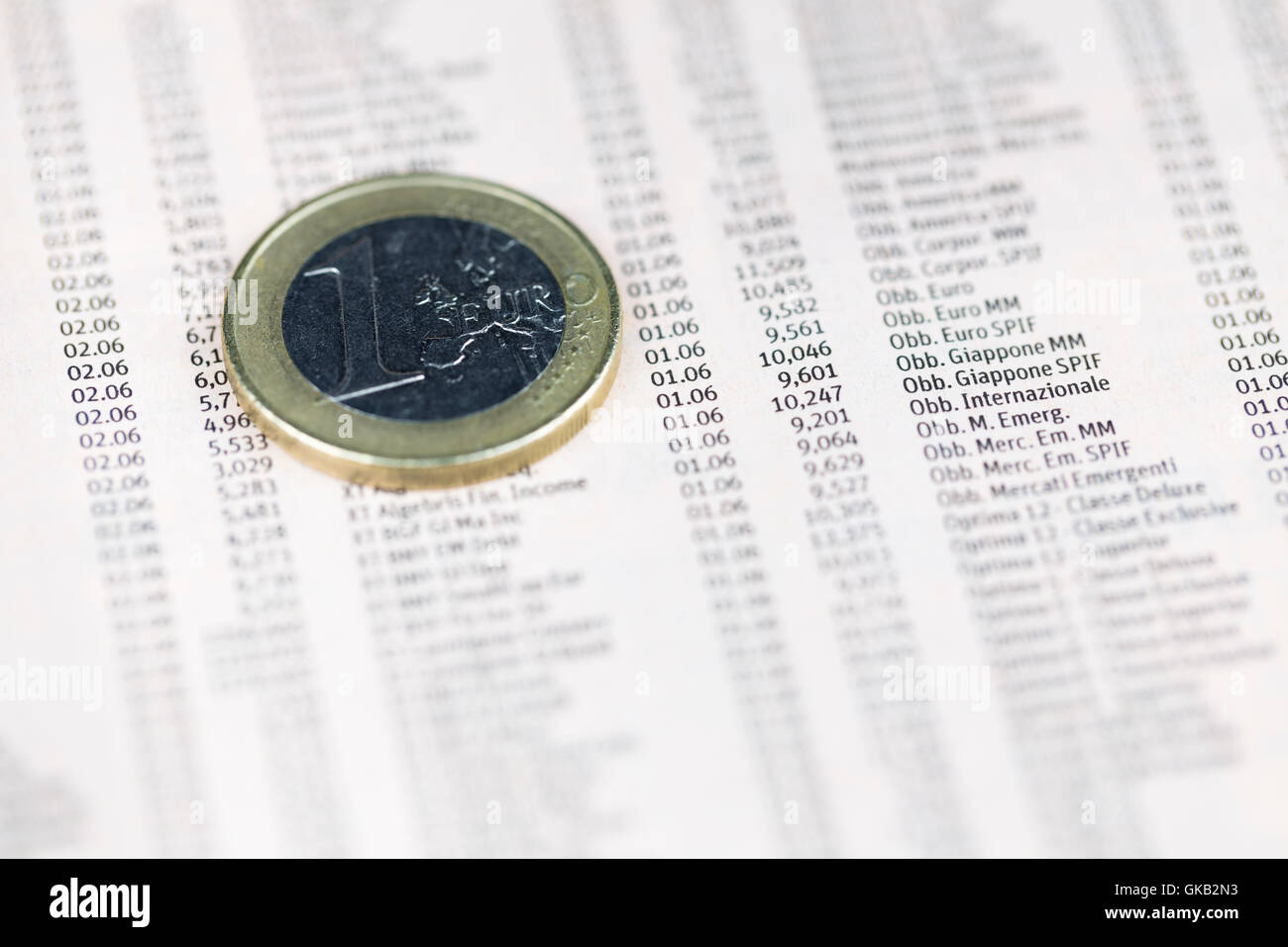 One euro coin over share prices, economy concept Stock Photo