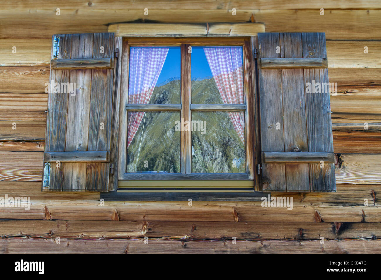 wooden hut with windows in the alps Stock Photo