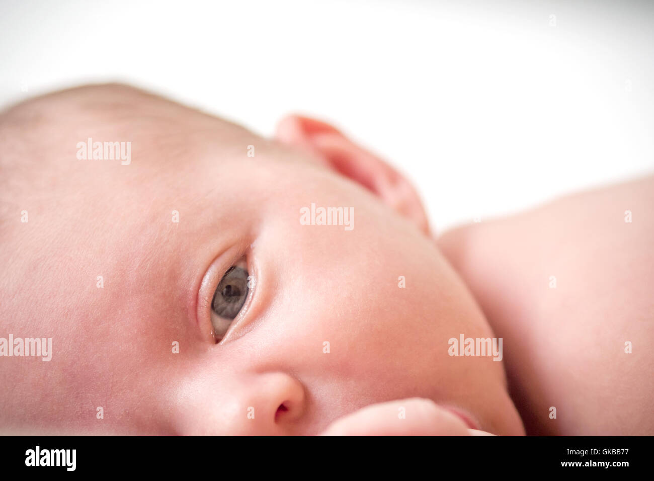 newborn-child-relaxing-in-bed-stock-photo-alamy