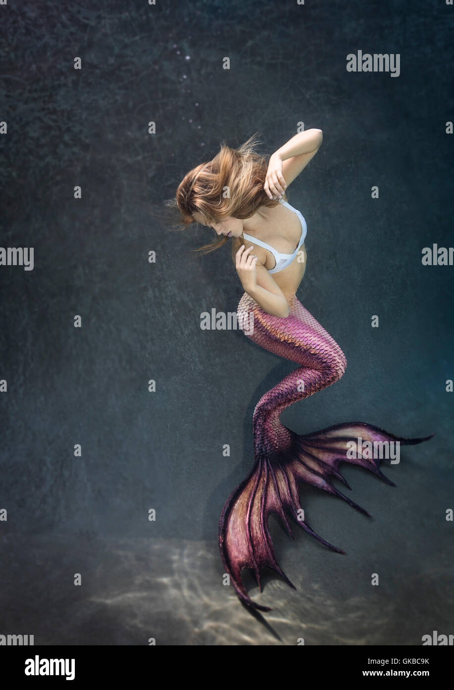 Young blonde mermaid in a pool, Virginia Beach, Virignia Stock Photo