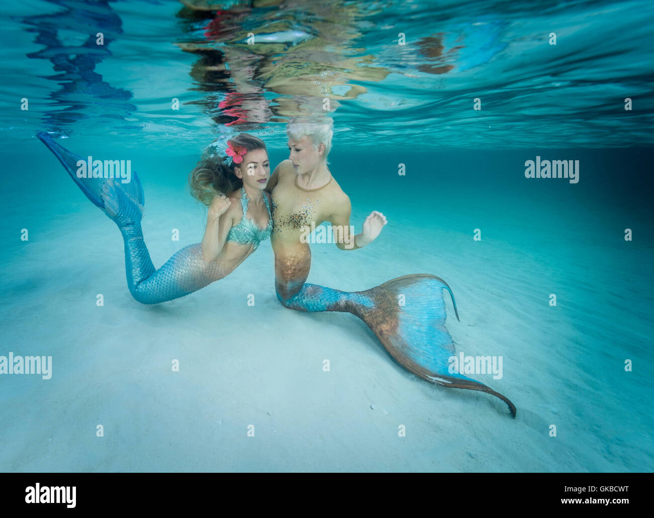 Two mermaids in the shallow waters of Exuma Cays in the Bahamas Islands Stock Photo