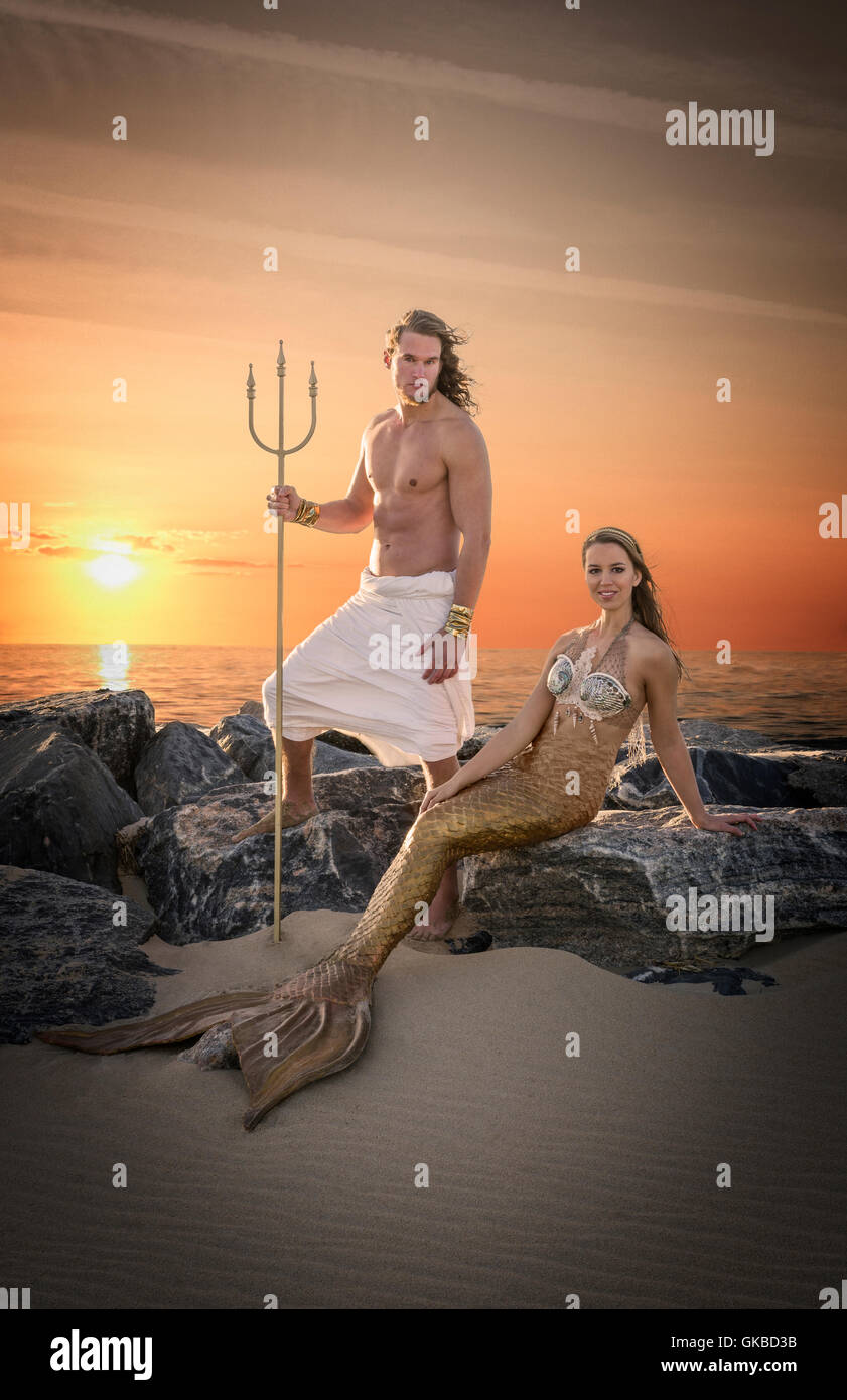 King Neptune and a mermaid on rocks by the beach, Virginia Beach, VA Stock Photo