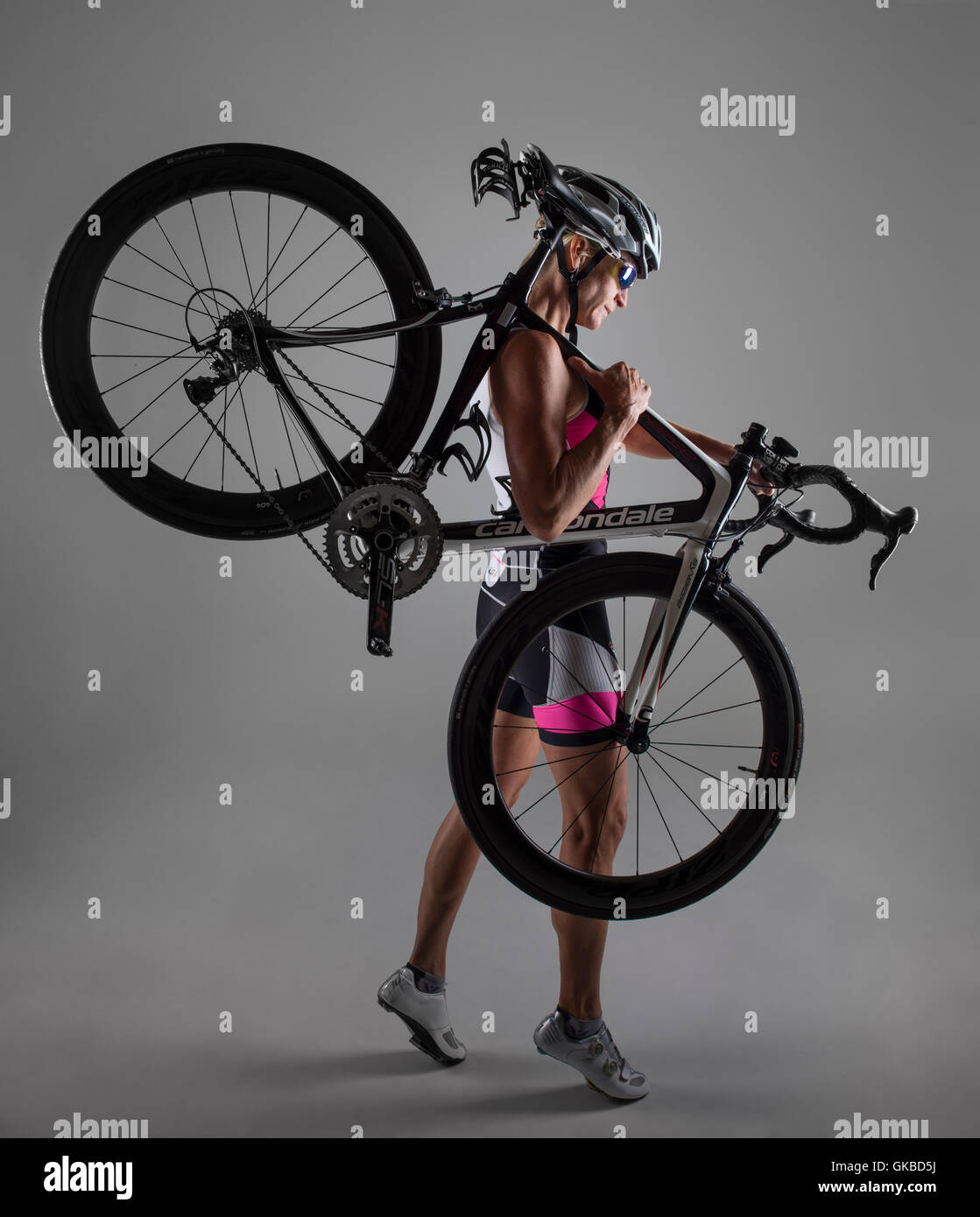 Woman in studio with her mountain bike Stock Photo